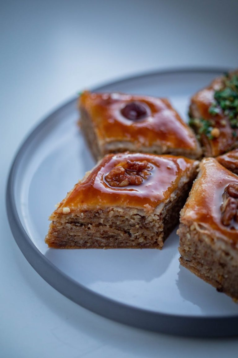 Close-up of delicious walnut baklava slices presented on a plate, showcasing rich textures.