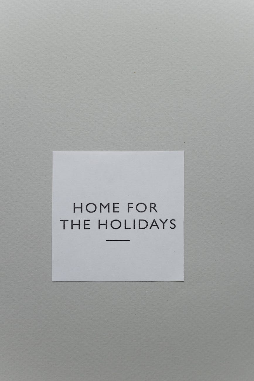 A simple 'Home for the Holidays' greeting card on a textured gray surface, perfect for festive messages.
