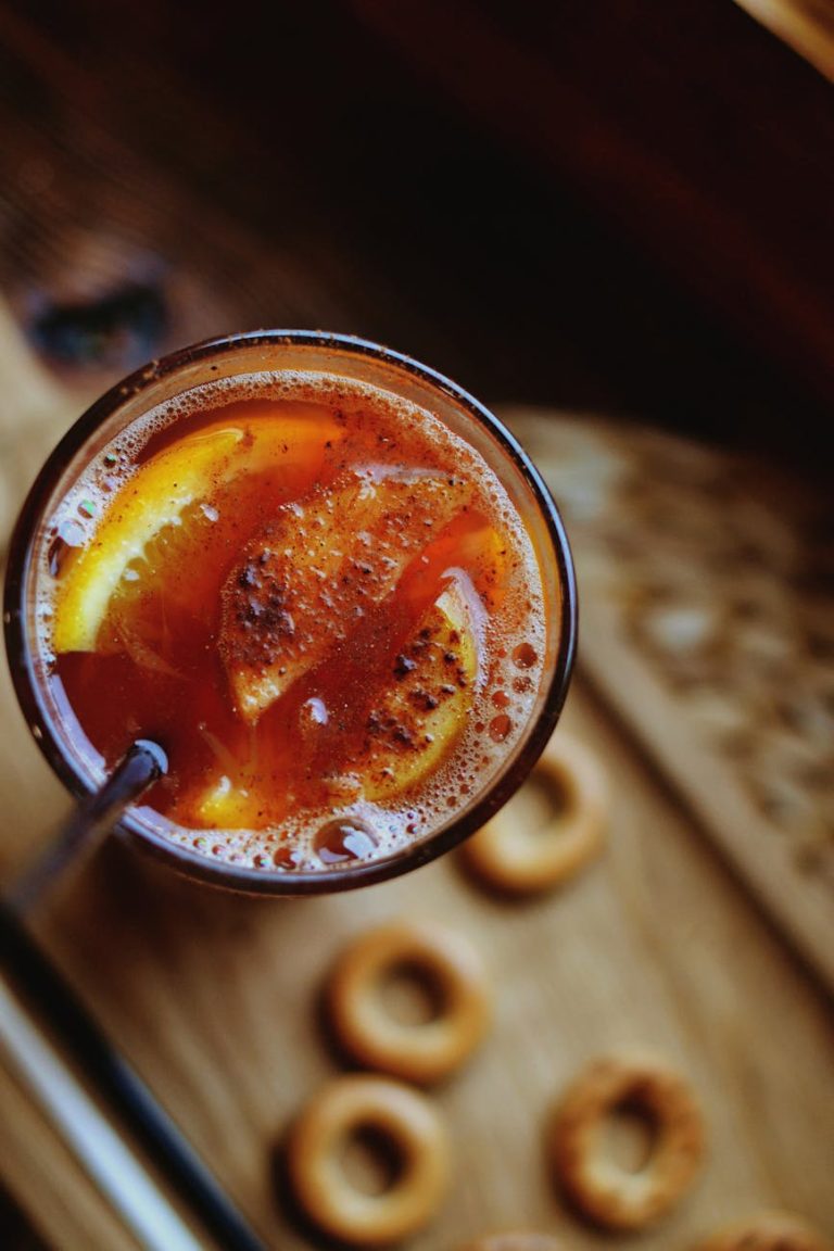 Top view of a spiced citrus drink in a glass with a straw, perfect for any occasion.