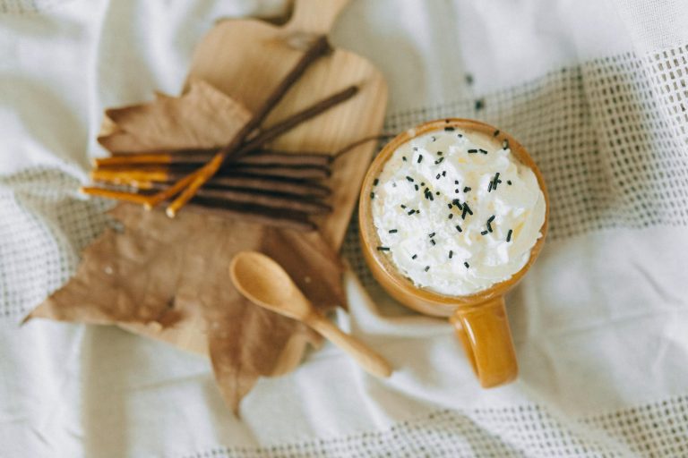 Warm cup of hot chocolate topped with cream, perfect for fall.