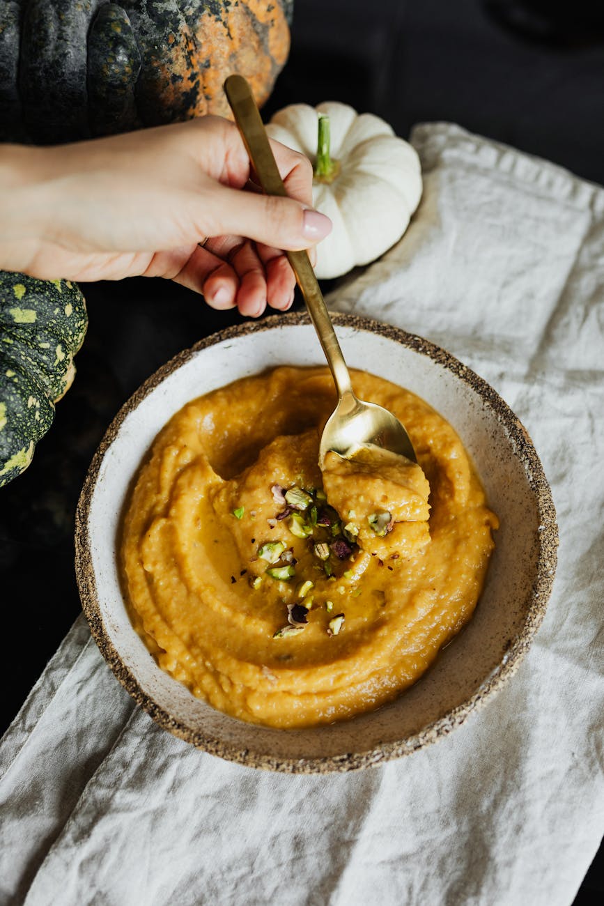 Delicious pumpkin puree garnished with nuts in a bowl, ready for serving.