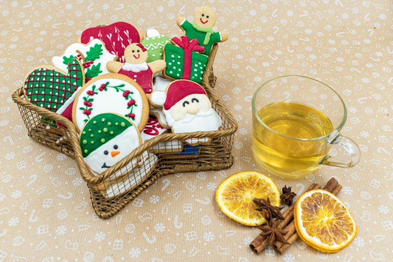 Festive cookies in a basket with a cup of tea, oranges, and spices. Perfect for holiday celebrations.
