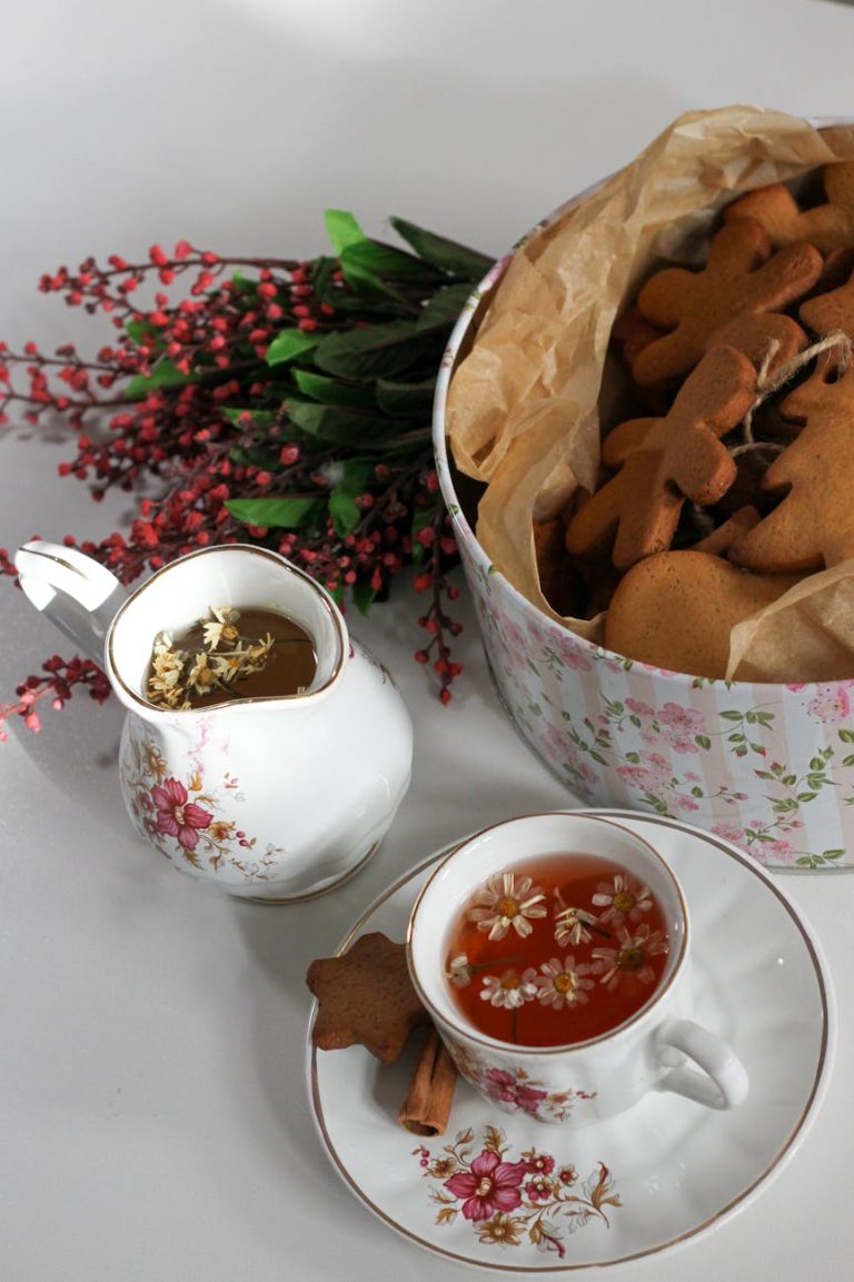 A cozy tea time setup with floral porcelain cup and gingerbread cookies.