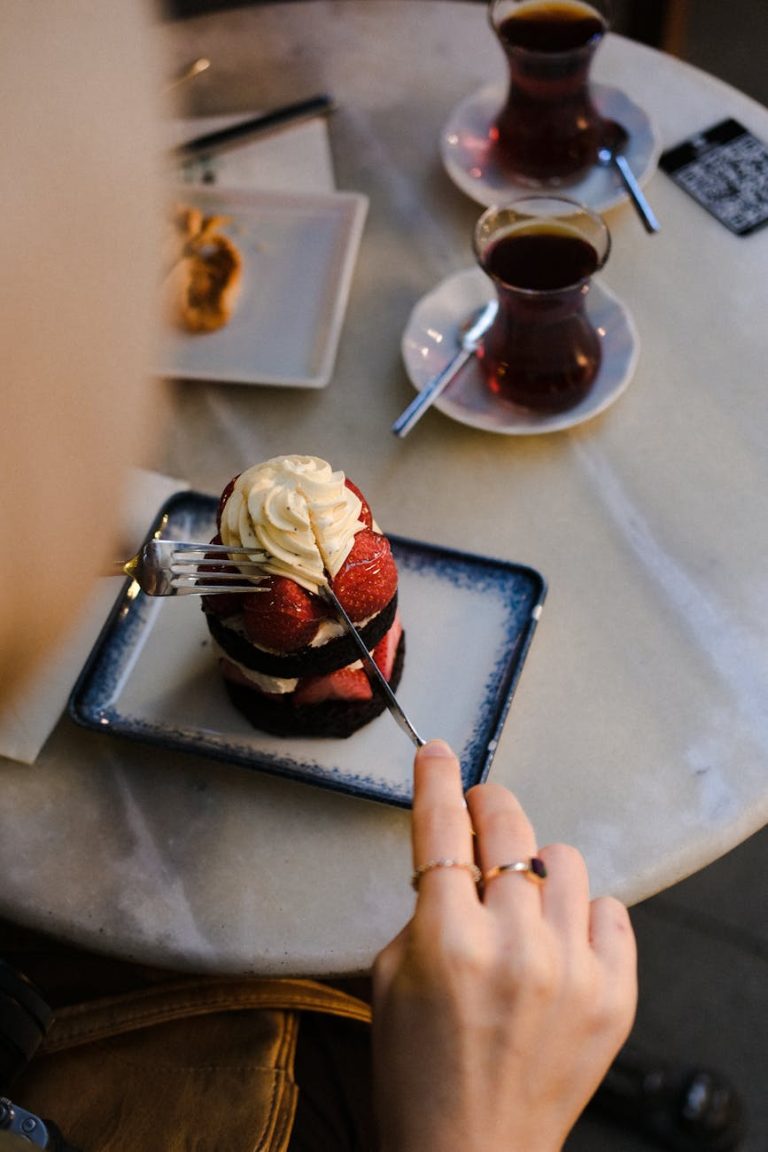 Enjoying strawberry cake and tea at a cafe in Istanbul, Türkiye.
