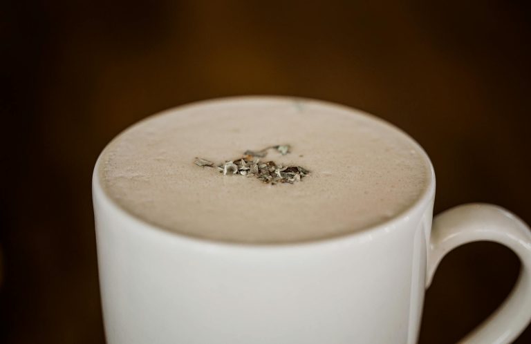 A delectable creamy beverage in a white mug, perfect for a warm drink.